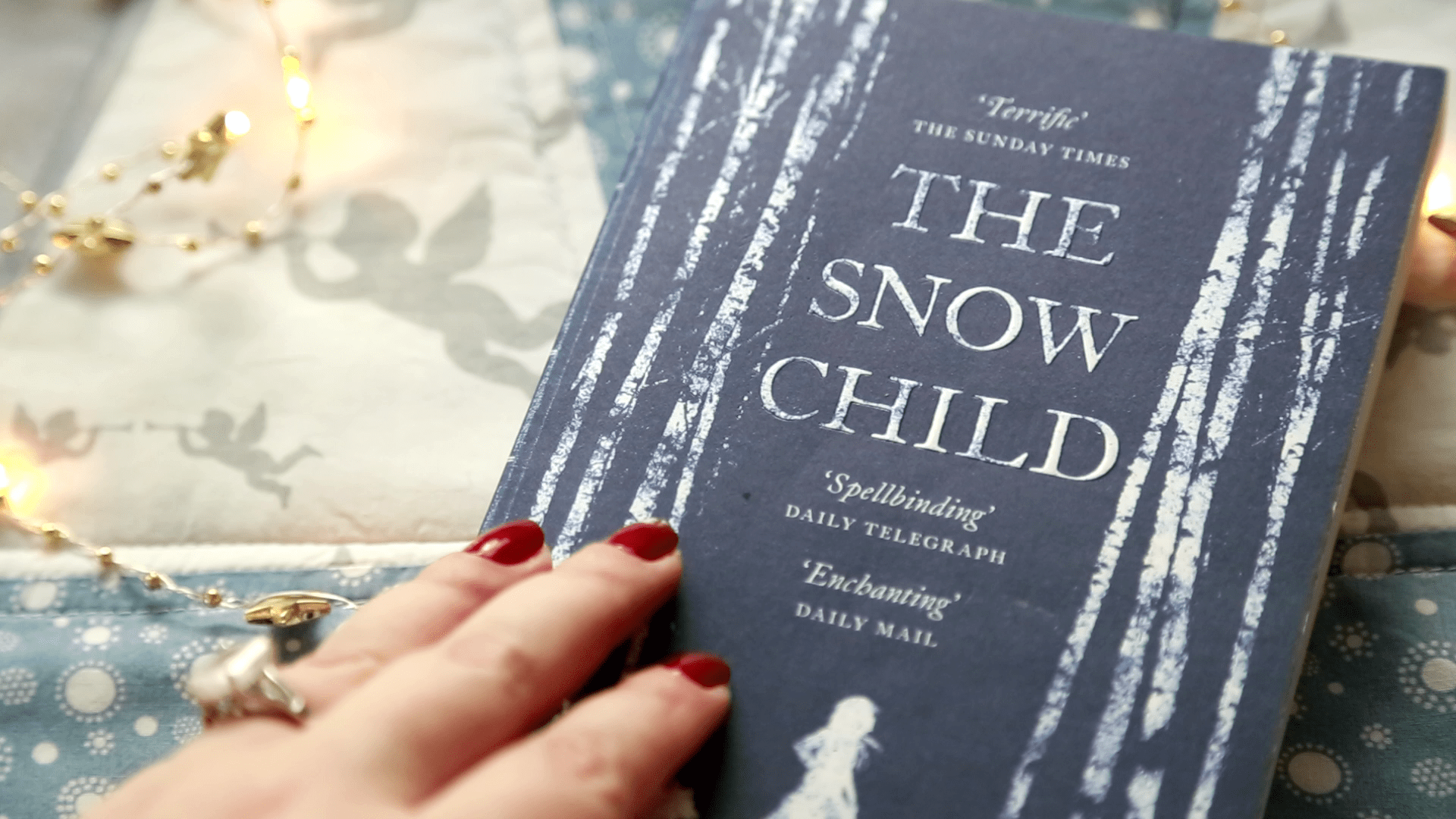 the novel The Snow Child by Eowyn Ivey as it's being opened by a woman
