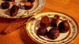 The ritual of tasting authentic Belgian chocolate, focusing on the snap and texture of the tempered shell.