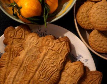 A plate of authentic Belgian speculoos cookies, showing the traditional golden-brown crunch.