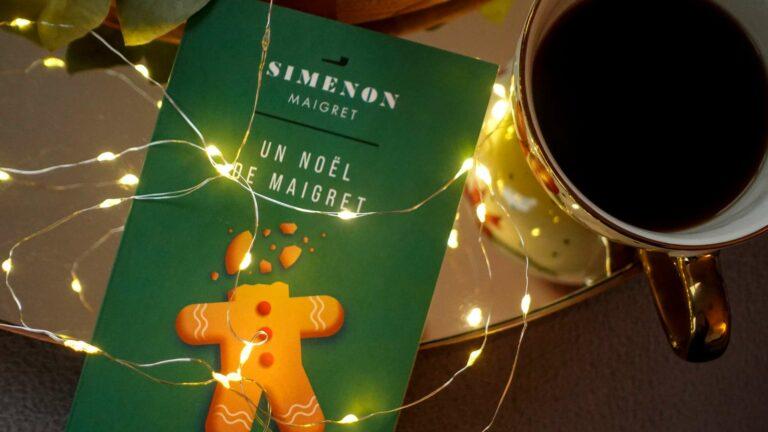 A copy of Maigret’s Christmas by Georges Simenon on a dark wood table with a cup of coffee.