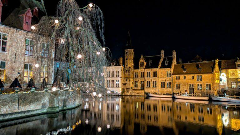 The atmospheric Rosary Quay in Bruges at night, reflecting the melancholy of Georges Rodenbach's novel Bruges-la-Morte.