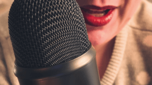 Woman recording a podcast on a Blue Yeti microphone, representing a slow reading ritual