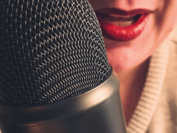 Woman recording a podcast on a Blue Yeti microphone, representing a slow reading ritual