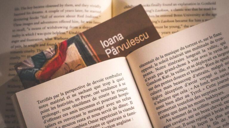 Close-up of two opened books stacked on top of each other, suggesting a cozy winter reading ritual.