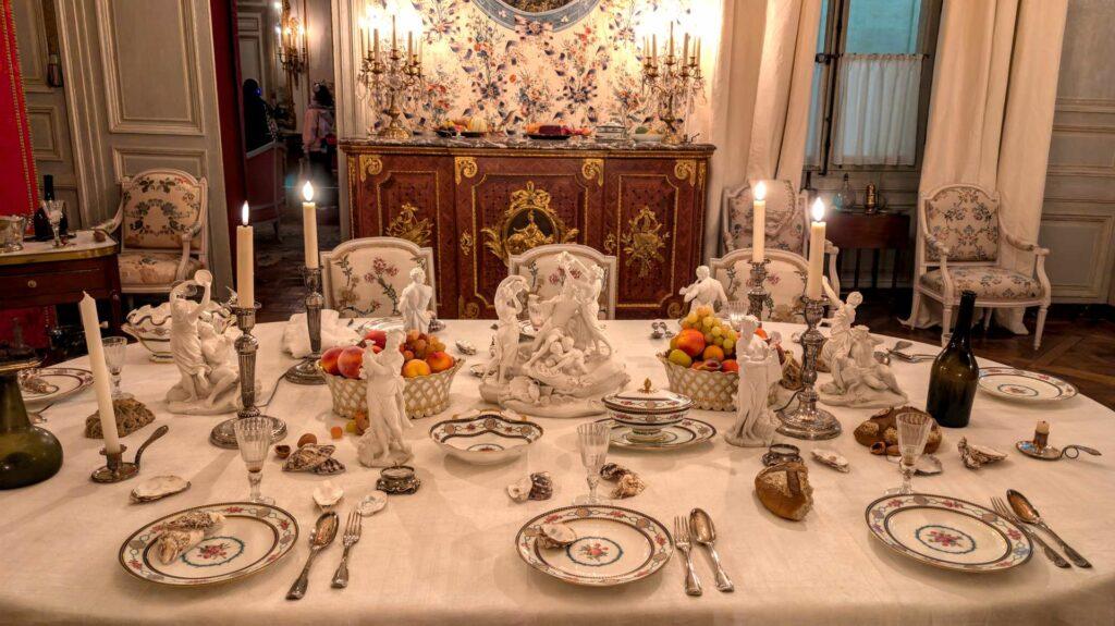 A traditional French formal table setting and cutlery placement in the Hôtel de la Marine in Paris