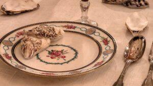 Close-up of a traditional French formal table setting and cutlery placement with Sèvres porcelain and oyster shells