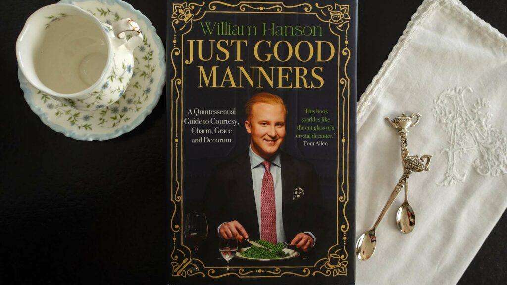 Flatlay of "Just Good Manners" by William Hanson, a contemporary guide to modern British etiquette and courtesy.
