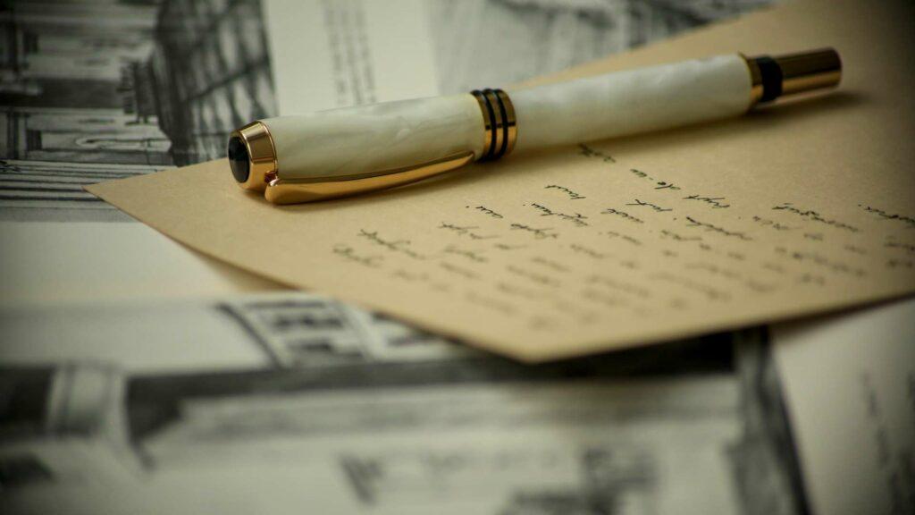 A fountain pen on a handwritten page suggesting research before chosing the next book to read